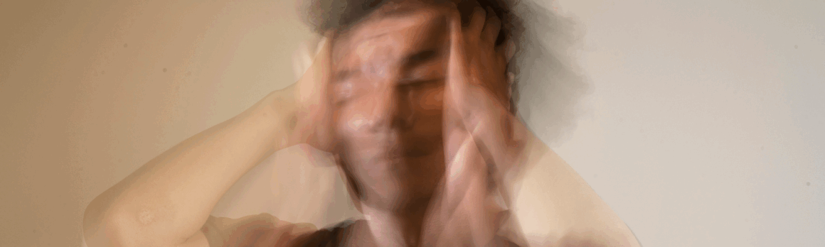 Person experiencing cognitive overload or anxiety, symbolizing symptoms of ADHD, memory issues, and need for neuropsychological testing.