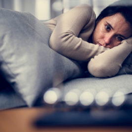 Chronically ill woman depressed in bed