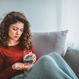 Woman taking medication to help with depression