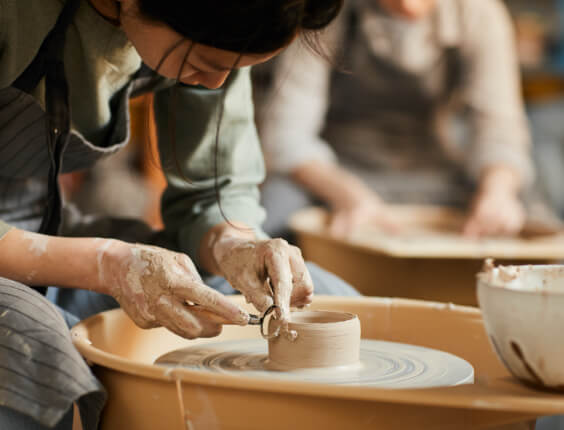 Woman creating pottery represents balance with medication.