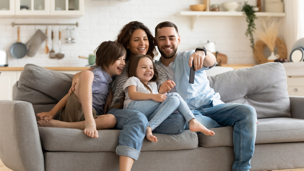 Positive parents with kids on the couch