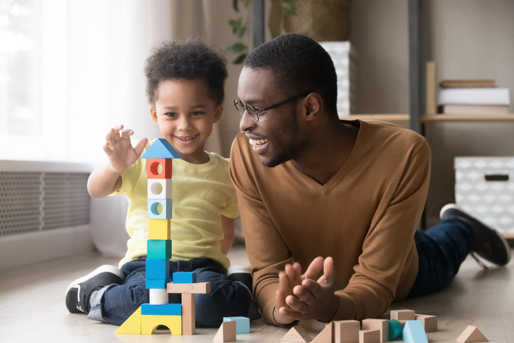 happy father and son building blocks